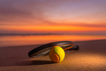Beach tennis racket. Background with copy space. Sport court at the beach and ball.