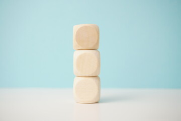 Stack of three natural wooden blocks showcasing balance and minimalism, versatile wooden cubes on clean background for business, health and education concepts.