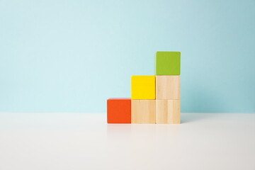 Colorful wooden blocks arranged in ascending order, symbolizing growth and organization, versatile...