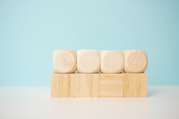 Wooden cubes arranged on clean surface with pastel background, showcasing simplicity and versatility. Versatile wooden cubes on clean background for business, health and education concepts.