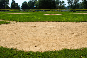 A baseball field, focusing on the infield area around the pitcher's mound and home plate. Sports background with copy space.