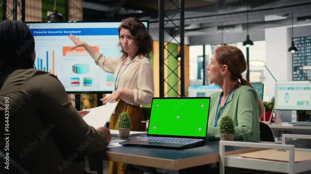 Poster powerful businesswomen using a laptop with isolated display, exchanging reports and strategy insight
