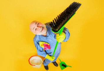 Big cleaning time. Smiling man in uniform with broom, selective focus. Professional cleaning...