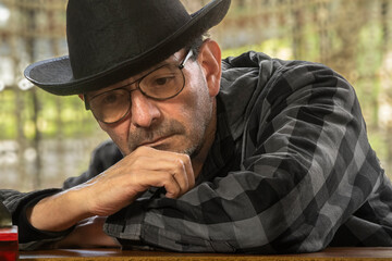 Portrait of an elderly man with a hat: active retired lifestyle