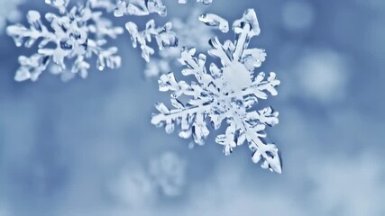 Close-up of delicate snowflakes against a soft blue background - Powered by Adobe
