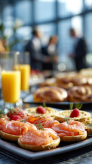 Catered event with open-faced salmon sandwiches, assorted pastries, and fresh orange juice. Great for business or personal gatherings.