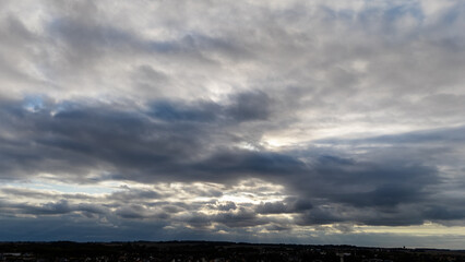 Dramatic cloudy sky with dark clouds over scenic horizon at dusk.