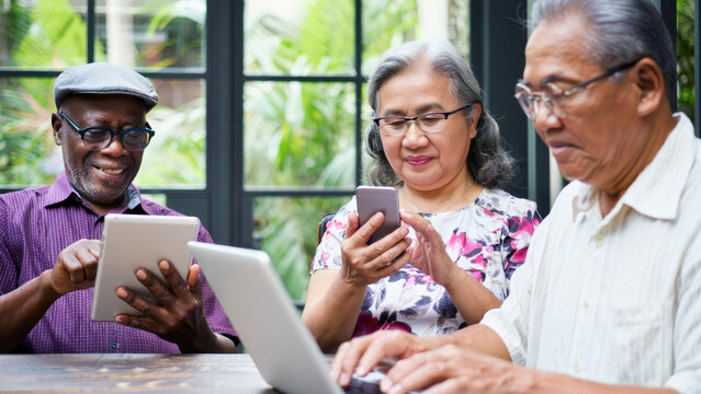 Group of seniors, digital devices, active aging, tech lifestyle, online engagement, modern communication, elderly using technology, tablet smartphone laptop, shared learning, connected seniors