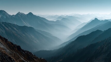Fototapeta premium Breathtaking view of layered mountain ranges with misty atmosphere and distant peaks under cloudy sky showcasing natural rugged landscape scenery