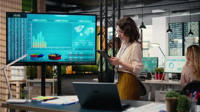 Empowered CEO examining monthly reports data for efficiency, guaranteeing multinational company success by reviewing indicators for strategic planning. Building strong vision. Camera A.