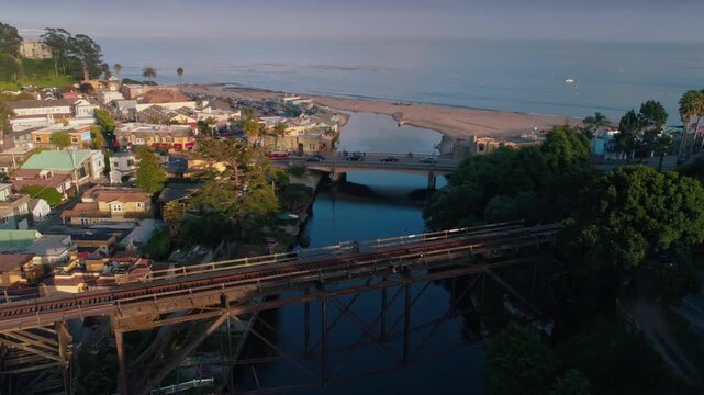 Aerial view of Capitola Village in California, USA. People are walking and driving across bridges to enjoy the beach and town.