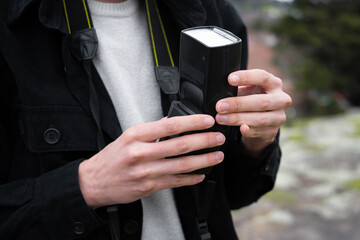 Young man photographer takes photographs with dslr camera in a city. Travel, vacations,...