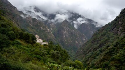 Misty mountain valley with temple nestled in the hillside.