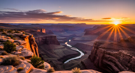 Stunning sunset over canyon landscape with river winding through the majestic cliffs and rock formations