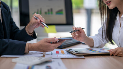 Business people analyzing financial charts and data on smartphone