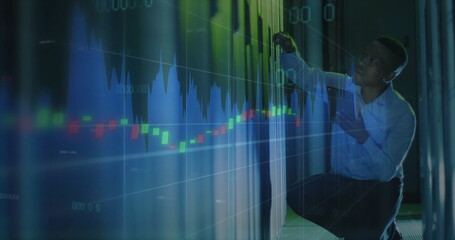 Kneeling IT technician reaching holographic data display in data center corridor, copy space