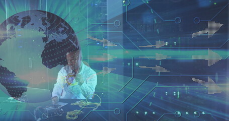 Holding yellow cables man in checkered shirt connecting circuit board at desk, with laptop graphics