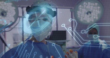Lead surgeon in scrubs and headlight conducting surgery in operating room, with holographic overlay