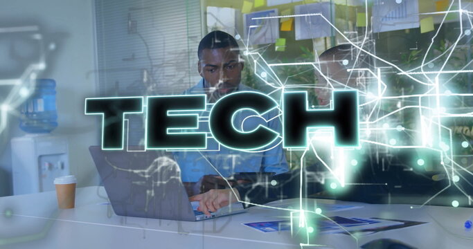 Collaborating IT pro and colleague analyzing code on laptop at office desk, with tech overlay