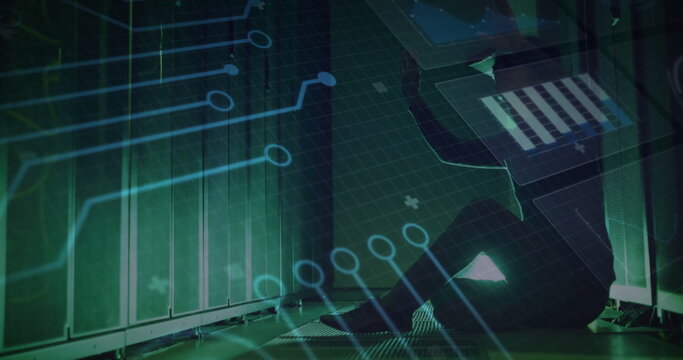 Crouching technician checking server racks in server room aisle with laptop and overlay, copy space - Powered by Adobe