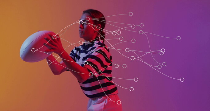 Adult athlete wearing striped rugby jersey preparing to pass rugby ball in studio, keypoint markers - Powered by Adobe