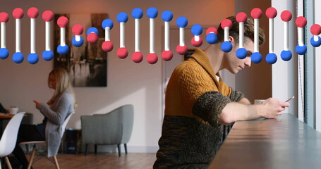 Leaning man in mustard sweater scrolling smartphone in café, with DNA helix graphic, copy space