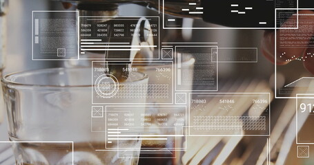 Espresso machine spouts pouring dark espresso into glass cup on café counter, with data panels