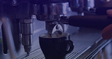 Espresso portafilter handle dispensing espresso at cafe counter, with black cup on steel drip tray
