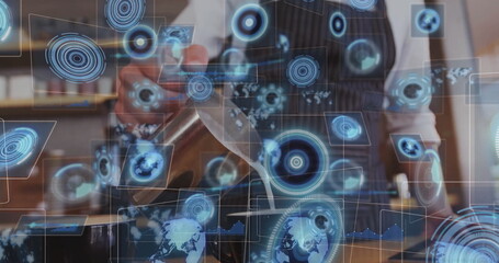 Pouring steamed milk from metal pitcher into ceramic cup at coffee shop counter, with holograms