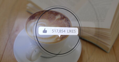 Naklejka premium Highlighting ceramic cup showing cappuccino foam art sitting on table, with book, fork and overlay