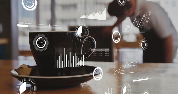 Resting black ceramic coffee cup and pastry on table at coffee shop, with floating digital charts