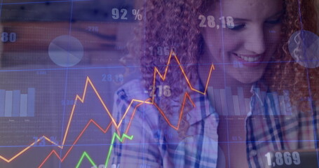 Analyzing data woman in plaid shirt reviewing line graphs, bar charts at office desk, copy space