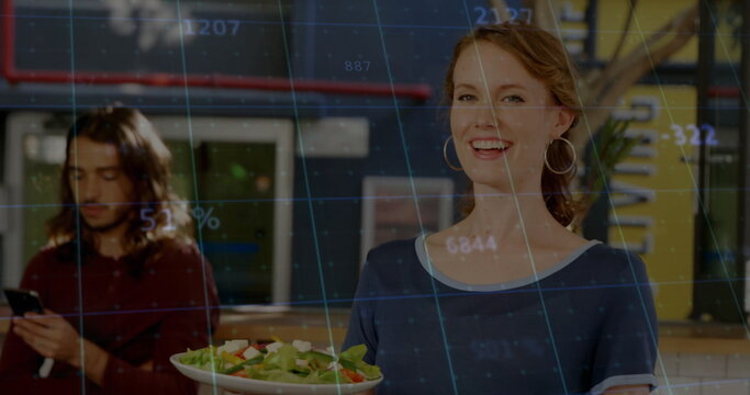 Holding server in navy tee presenting fresh salad at cafe counter showing data overlay, copy space