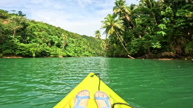 First-person kayak ride on Lobok river surrounded by tropical jungle on Bohol island, Philippines Peaceful kayaking through lush green Lobok river on Bohol island, Philippines, from first-person view
