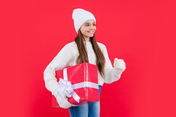 new year holiday. smiling teen girl with new year gift in studio. teen girl hold new year gift