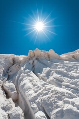 Bright Sun over White Rock Formations Under a Clear Blue Sky