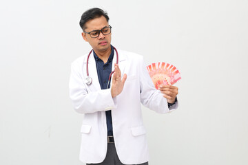 Asian male Doctor Refusing Money. Isolated on white