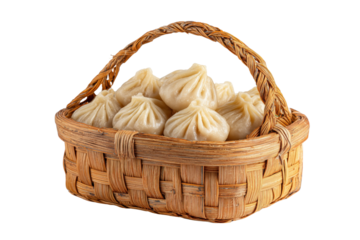 Woven basket filled with steamed dumplings against a black background isolated on a transparent background