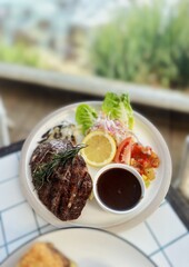 Steak with Salad and Lemon on Plate