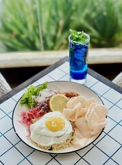 Fried Egg and Rice Dish with Blue Mocktail