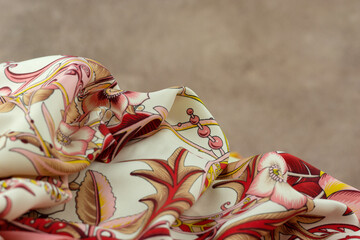 Silk colorful fabric on abstract textured background. Soft delicate fabric for sewing close-up.