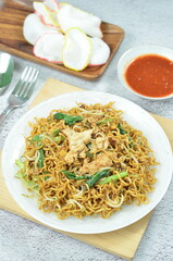 Indonesian style stir fry noodles with, egg,  green mustard, chilli and crackers.