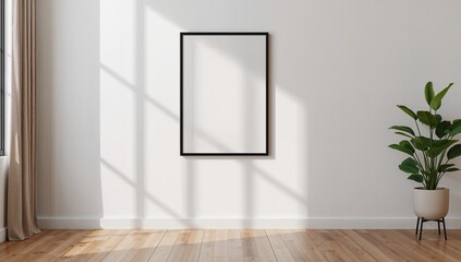 Vertical black frame mockup on white wall with potted plant and sunlight