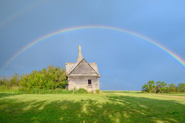 Prairie Abandoned House Under a Vibrant Rainbow in Alberta