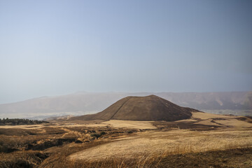 March 25 2025 Brown Hill in Vast Open Landscape with Mountains in the Distance, Japan