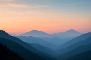 Fototapeta premium Serene mountain peaks at dusk with soft orange sky