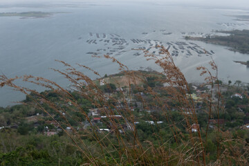 Photographic view of an Asian lakeside village with aquaculture for travel and environmental themes