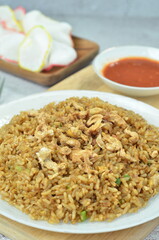Delicious fried rice with egg, chilli, crackers and green onion, Indonesian dish.