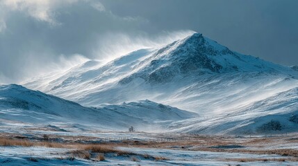 Snow-covered mountain peak under a dramatic sky