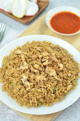 Delicious fried rice with egg, chilli, crackers and green onion, Indonesian dish.